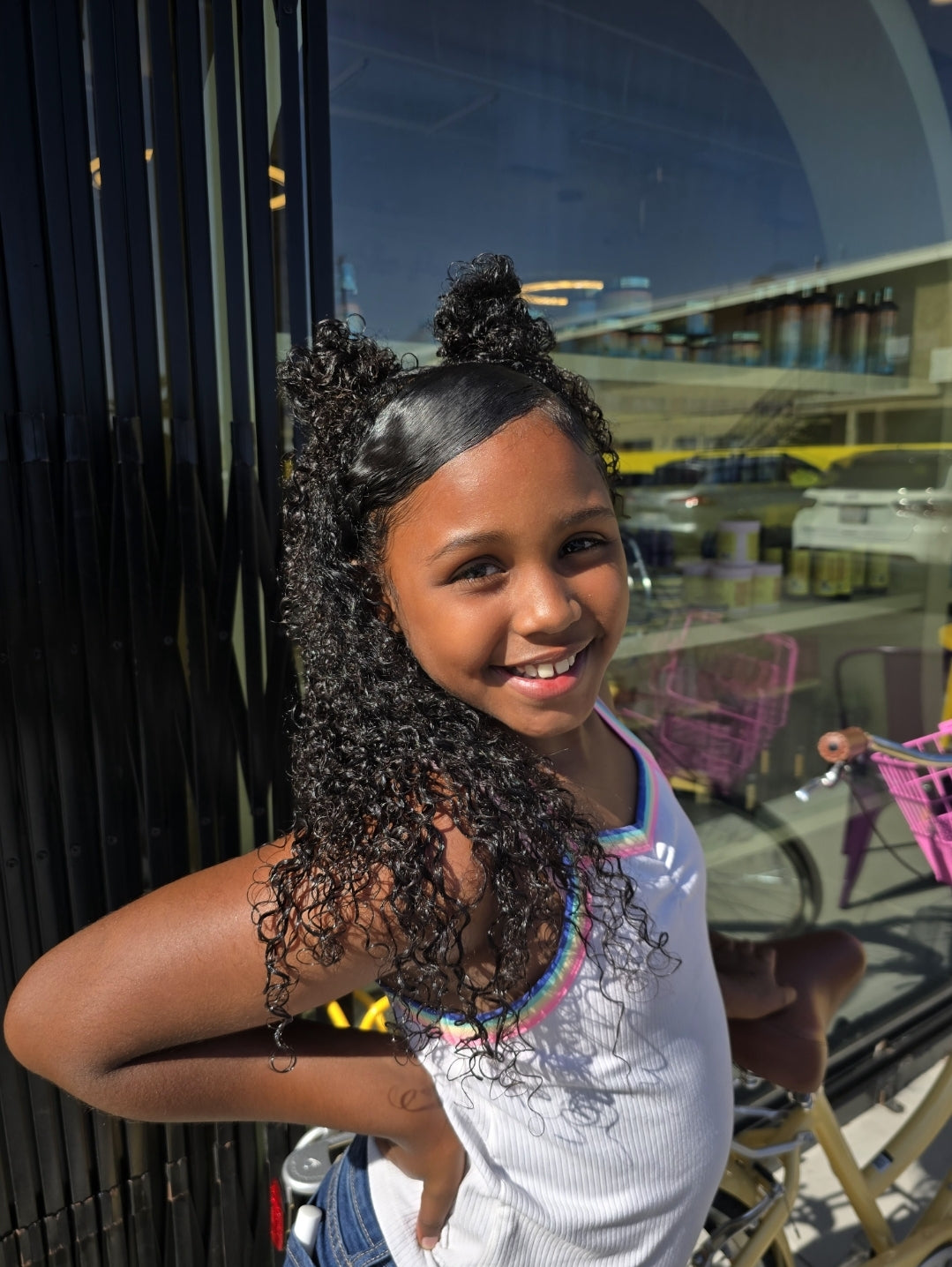 A person applying Lushus Hair’s Curly Styling Starter Kit to deeply hydrate and define their tight curls