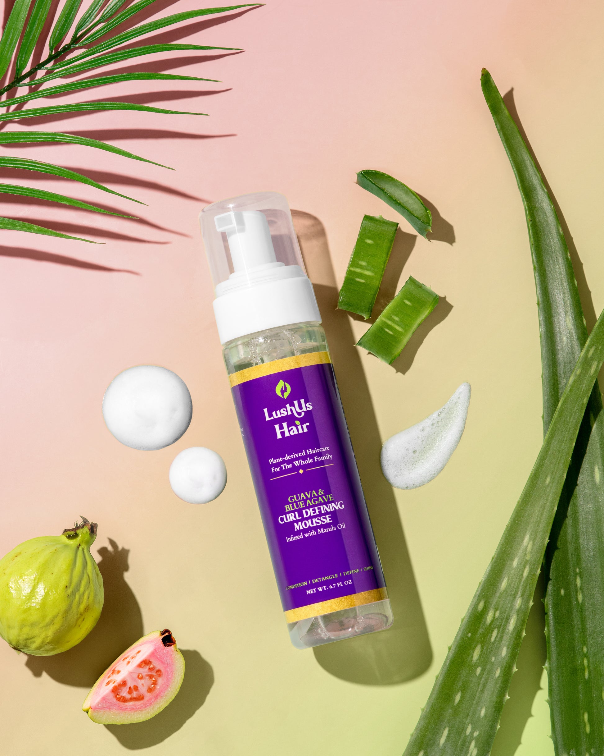 Lush Hair product bottle with aloe vera leaves and guava on a gradient background