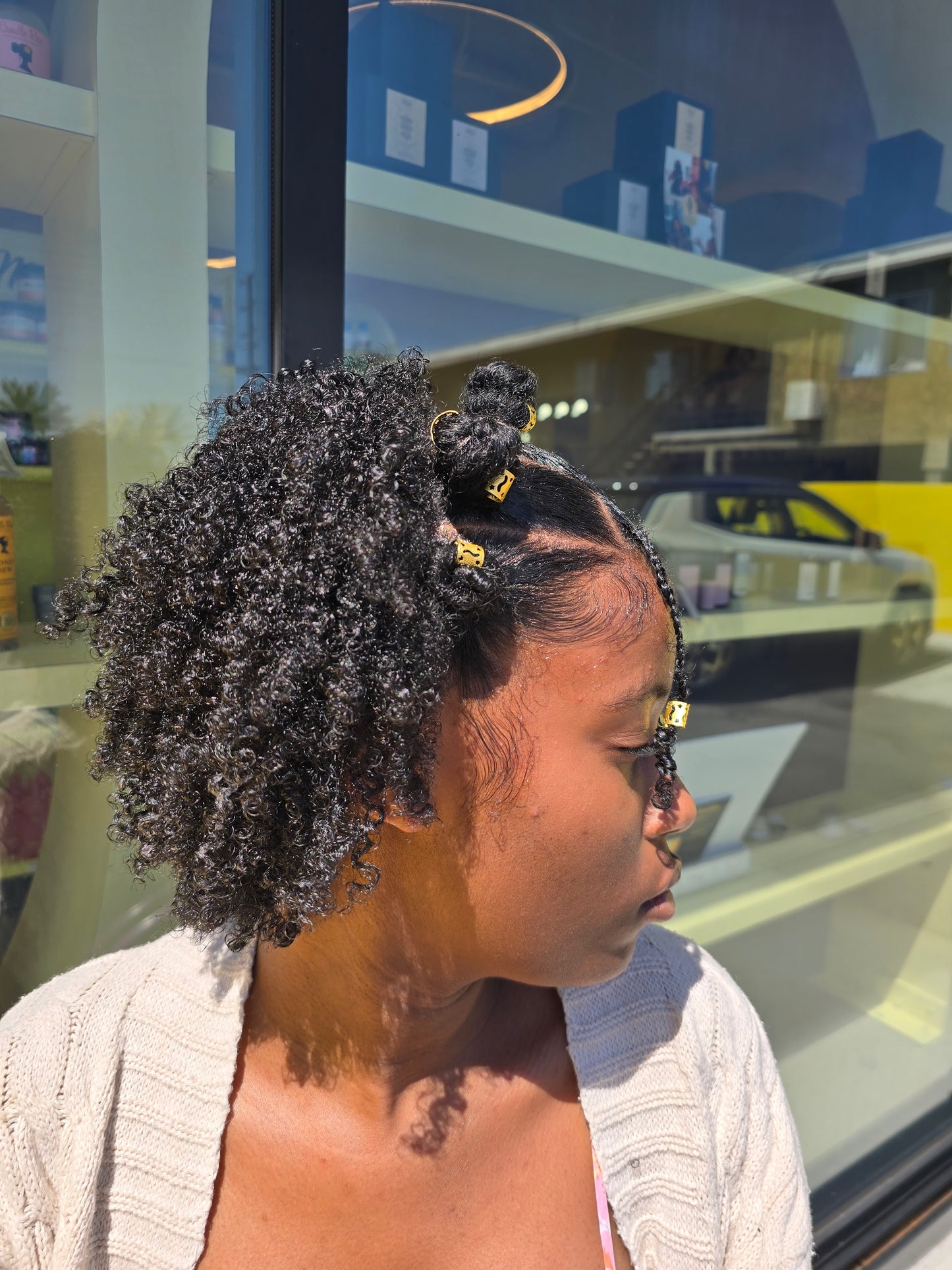 A person using the Curly Styling Starter Kit, applying Lushus Hair products for healthy, defined curls.